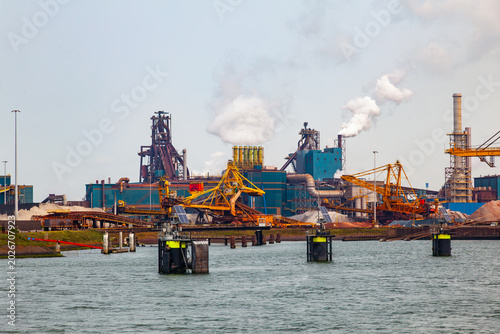 Tableau sur toile Industrial steel factory and port terminal with smoking chimneys and heavy machi