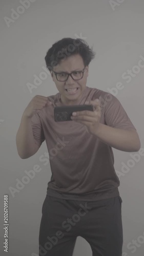 Southeast Asian person watch football on their mobile phones, then get disappointed when their team fails to score S-Log3, S-Gamut3.Cine
