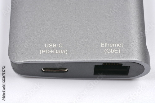 Obraz na płótnie Close up view of a grey aluminum USB-C hub showing a USB-C port and a Gigabit Ethernet port with printed text labels