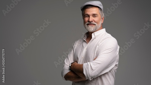 Bilde på lerret Smiling man wearing white shirt and flat cap, close-up