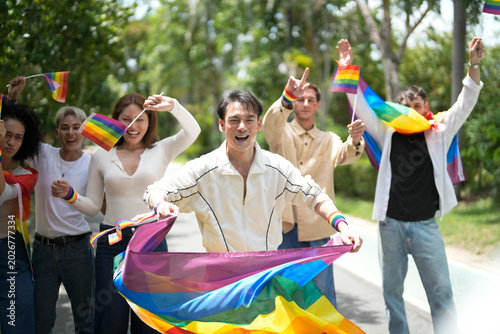 Fotografie Diverse group of people celebrating at a pride parade with rainbow flags