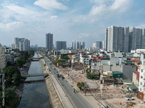 Tableau sur toile Aerial view of demolition and land clearance along Tam Trinh Road redevelopment project with canal and high rise apartments in Hanoi