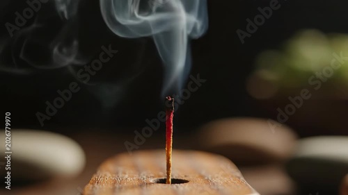 Vertical Incense Stick with Bright Red Glowing Ember Emitting Thin Ascending Smoke