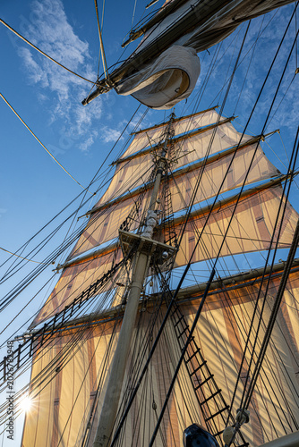 Low angle view of mainmast tied with intricate arrangement of ropes on tall ship