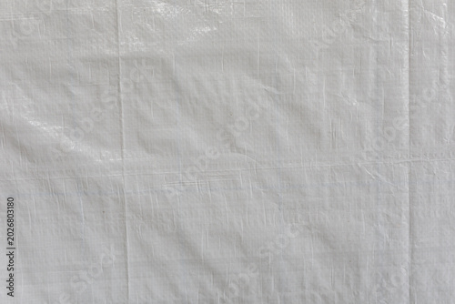 Close-up abstract view of a durable white woven tarp texture and background