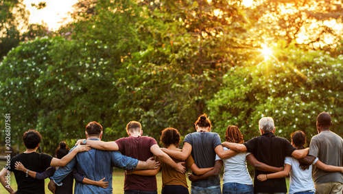 Photography Diverse group of people standing outdoors, arms around each other