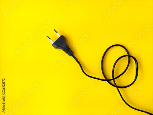 Foto European two-pin power cord on bright yellow background