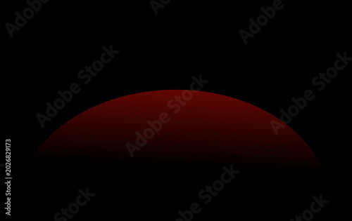 Dramatic red sunset horizon over dark landscape with glowing sky and silhouette