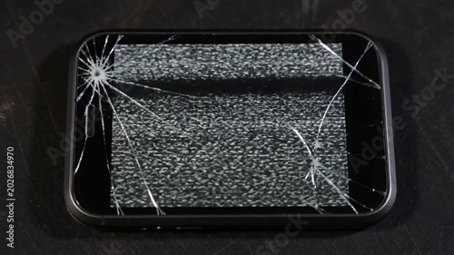 A 4K stop motion showing a dead LED phone screen with gritty, cracked textures and flickering static noise in a grunge aesthetic.
