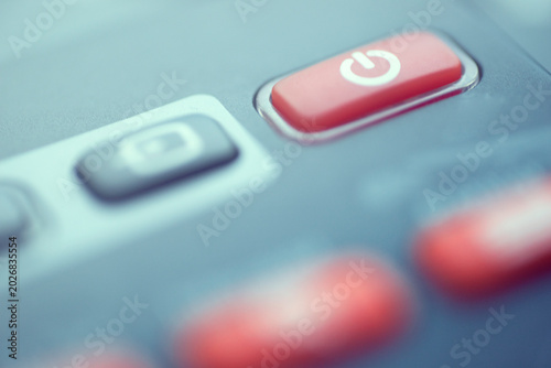 Quadro em tela Macro shot of a red power button with standby symbol on a remote control