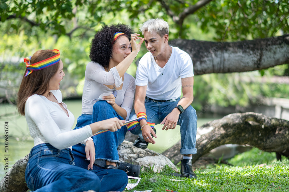 Fototapeta premium Group for human rights.Lesbian, ally, happy people for LGBTQ support in nature,relax with identity equality. Friends, pride flag, women in park with smile for bonding, community. Pride month. concept