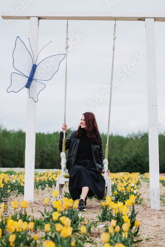 A young woman in a field of tulips. 