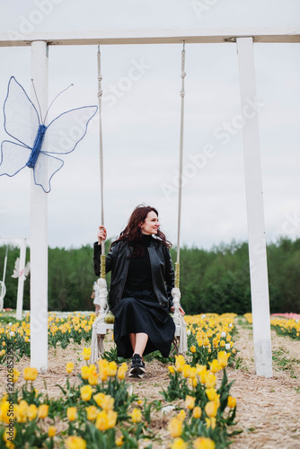 A young woman in a field of tulips. 