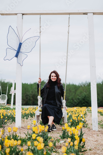 A young woman in a field of tulips. 