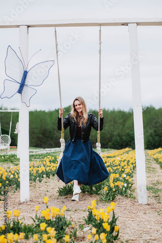 A young woman in a field of tulips. 