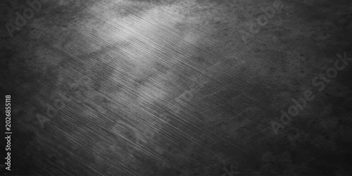 Dark brushed metal texture background with grunge industrial surface and worn metallic abstract pattern