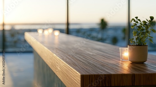 Warm sunset light illuminates a wooden bar with candles and plant