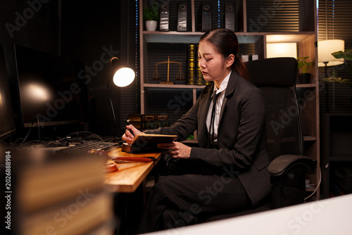 Bild auf Leinwand Focused Businesswoman Working Late on Laptop in Dark Office