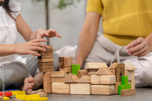 Photos Happy children play and learn, education, homeschool little girl create wooden t