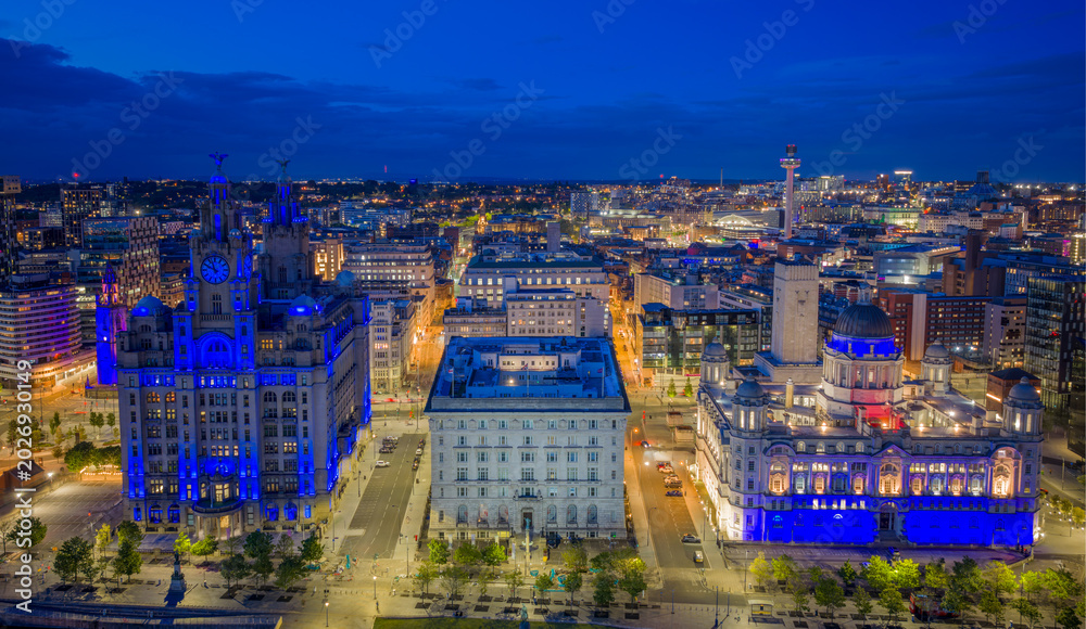 Fototapeta premium Liverpool, England. aerial view of Pier Head with the Three Graces including the Royal Liver Building and Port of Liverpool Building beside the River Mersey waterfront.