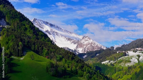 huge mountain in switzerland alps gets revealed with aerial shot and fresh snow in spring