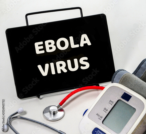 blood pressure monitor and digital tablet with ebola virus text displayed