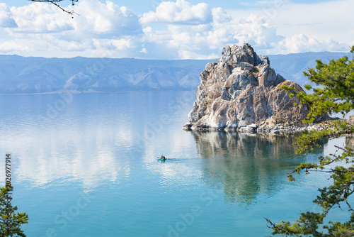 Beautiful summer landscape of Siberian Lake Baikal on a summer day. Tourists come to Olkhon Island to relax on the shore, ride a rubber boat near the famous Shamanka Rock, and explore the island