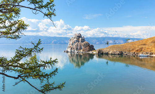 Beautiful summer landscape of Siberian Lake Baikal on a summer day. View of the famous Shamanka Rock and Cape Burkhan – the main attraction of Olkhon Island and a popular tourist destination