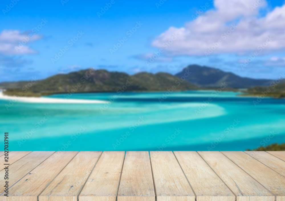 Fototapeta premium Wooden table top on the beach or sea.Party on the beach sunshine time concept.For montage product display or design key visual layout.View of copy space.