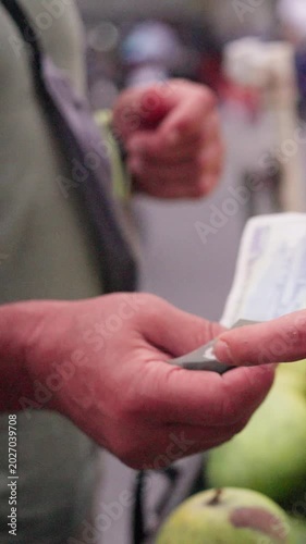 Trading Cash Amid Fruit Marketplace. Exchanging Currency During Lively Outdoor Fruit Market Negotiations. Financial Exchange Taking Place Amidst Outdoor Fruit Selling And Bargaining Activities