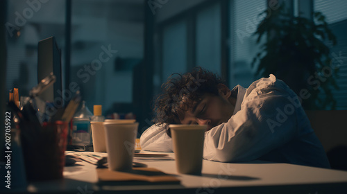 tired office worker late evening, messy desk