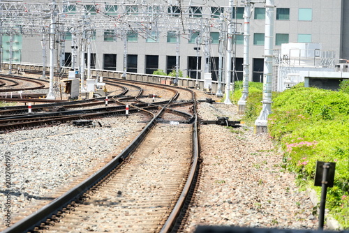 Canvas Print Scenery of railway tracks leading to the future through the hustle and bustle of