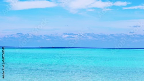 Beautiful sunny clear blue sky n deep sea horizon with white cloud or fluffy cloudscape n boat sailing on calm ocean wave in tropical summer or spring sunlight n sun ray at daylight sunshine day