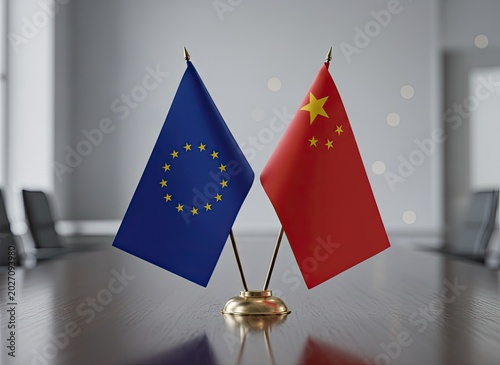 European Union and Chinese national flags standing together on a polished wooden boardroom meeting table