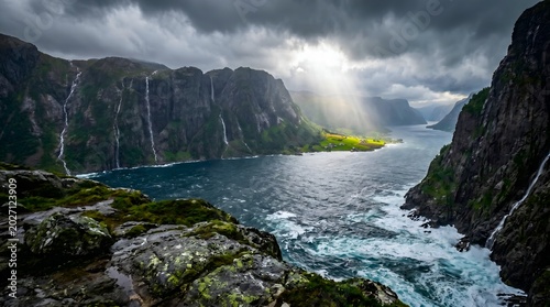 Dramatic fjord landscape with steep mountains, multiple waterfalls, and sun rays breaking through dark stormy clouds over a vast body of water