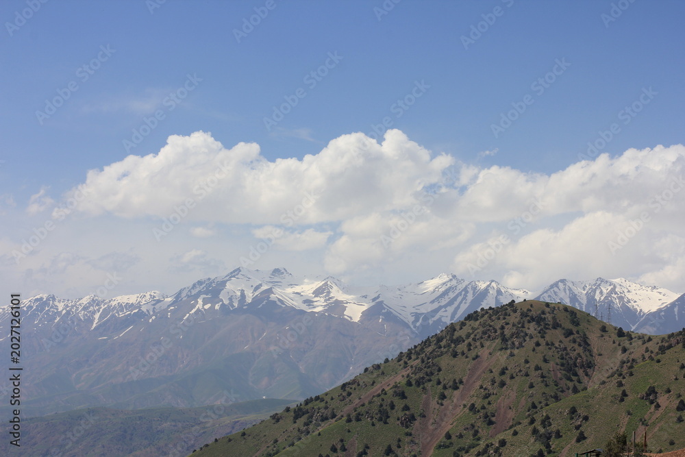 Fototapeta premium A view of snow-capped mountains in Uzbekistan in spring