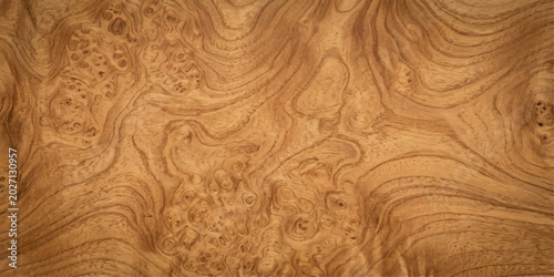 Close-up of natural burl wood texture with intricate swirling grain patterns and rich, warm brown tones, showcasing organic beauty and sophisticated design.