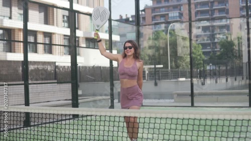 Slow motion Happy woman with racket playing padel
