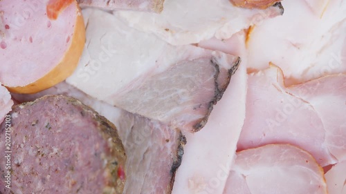Gourmet meat platter. Elegant arrangement of ham and sausage slices on platter. Stylishly arranged selection of finely sliced cured meats with appealing presentation