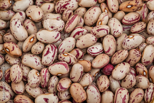 Photos Close-up of dried pinto beans with red and white markings