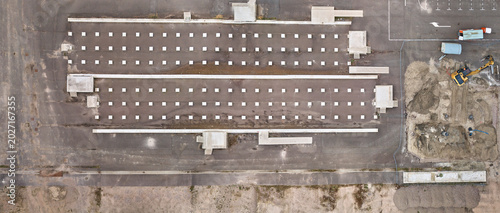 Middenmeer, Netherlands - 15 April 2026: Aerial view of Microsoft Datacenter Campus AMS showing foundations for a container-based battery park and construction machinery.