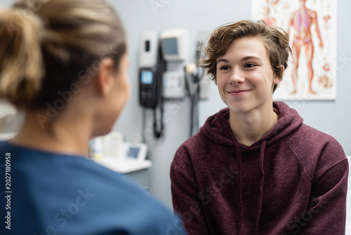 Smiling Teen Boy Patient Consulting with Doctor in Clinic Office