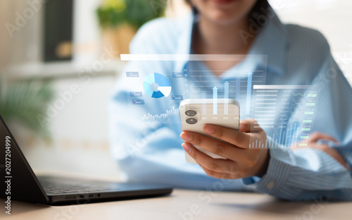 Businesswoman using smartphone for investment and mobile banking, managing money, budget, and financial funds through digital technology and smart business planning.
