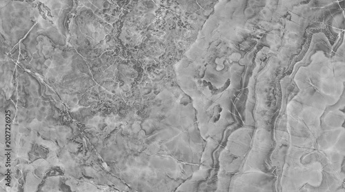 A detailed macro shot of a grey marble surface with intricate veins and textures, showcasing the natural beauty of the stone