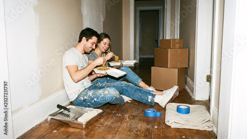 Couple Eating Noodles On Hallway Floor During Late Night Apartment Repainting Break, Disposable Flash Home Renovation Lifestyle