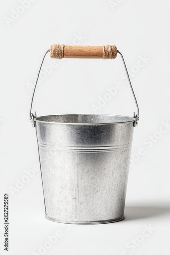 A silver bucket with a wooden handle rests on a white background