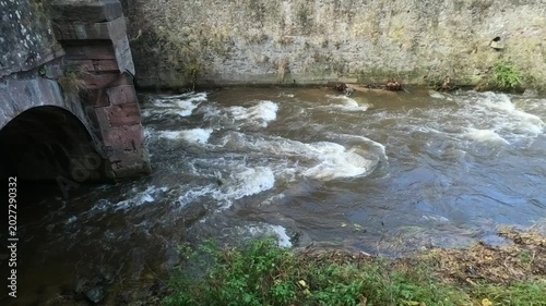 The Weiss river running between half timbered houses, Kaysersberg, Alsace, France, Europe. River with strong current flowing through the rocks.
