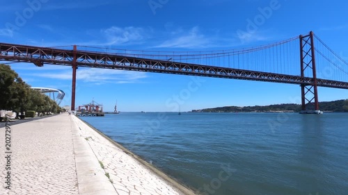 Christ-King and the 25 April Bridge (Ponte 25 de Abril), a steel suspension bridge located in Lisbon, Portugal, crossing the Tagus River (Rio Tejo).