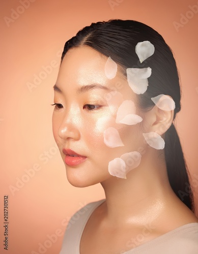 Glowing Skincare Portrait Of Young Woman With White Flower Petals Conveying Natural Beauty