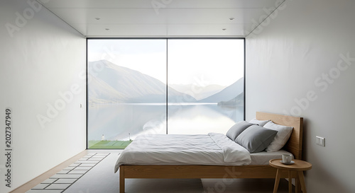 Modern minimalist bedroom with bed and table by large window overlooking lake and mountains transparent background